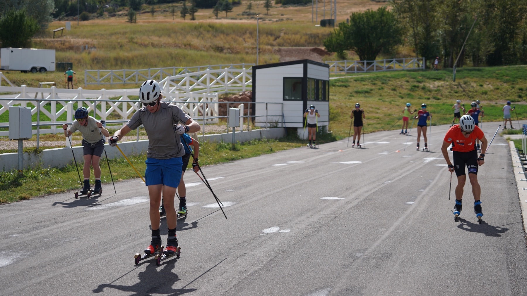 Camp athletes climbing together on rollerskis